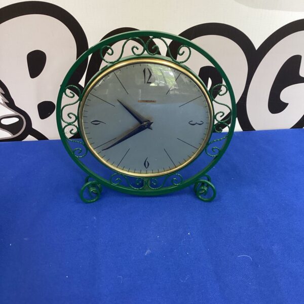 Vintage Tempora mantle clock with a circular face and elegant hands.