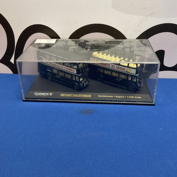 Pair of Oxford Diecast Guinness buses in display case.