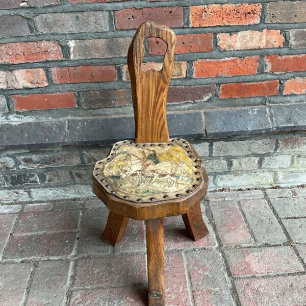 Vintage milkmaid stool with detailed leather hunt scene.