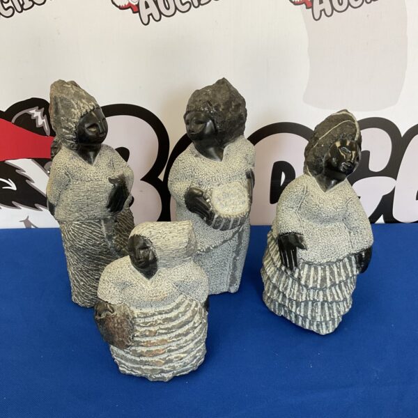 Four signed Lameek Mullion Shana stone sculptures displayed together.