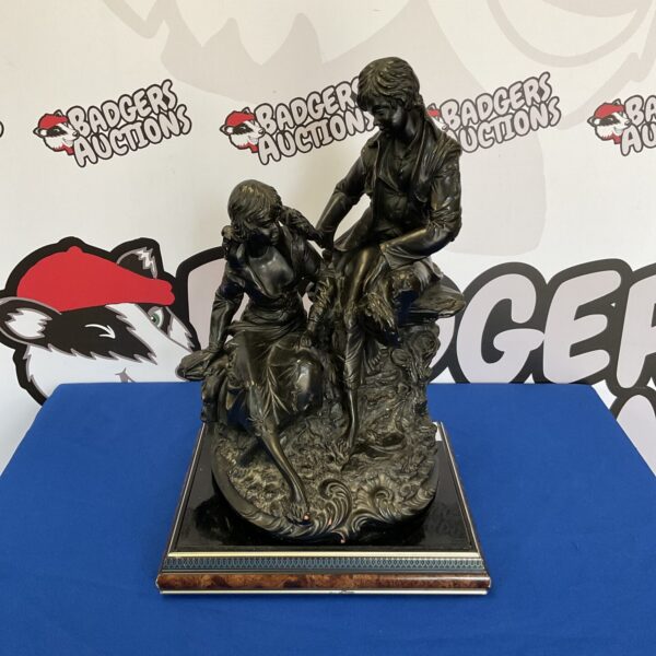 Vintage bronze lovers sculpture, detailed terracotta art piece.