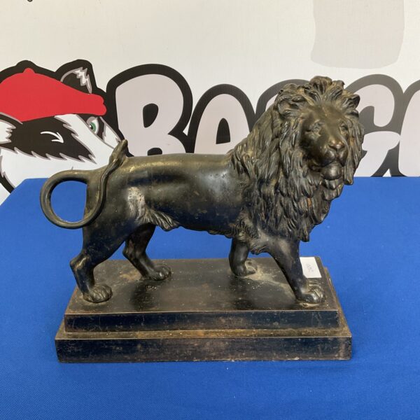 Detailed bronze lion sculpture, vintage animal statue.