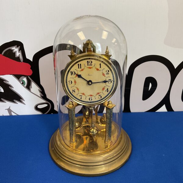 Vintage Kess anniversary clock with glass dome and gold base.