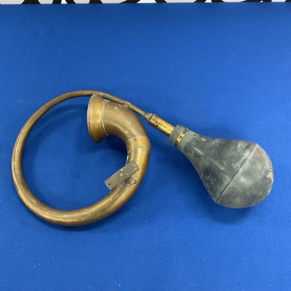 Vintage brass car horn with bulb actuator.