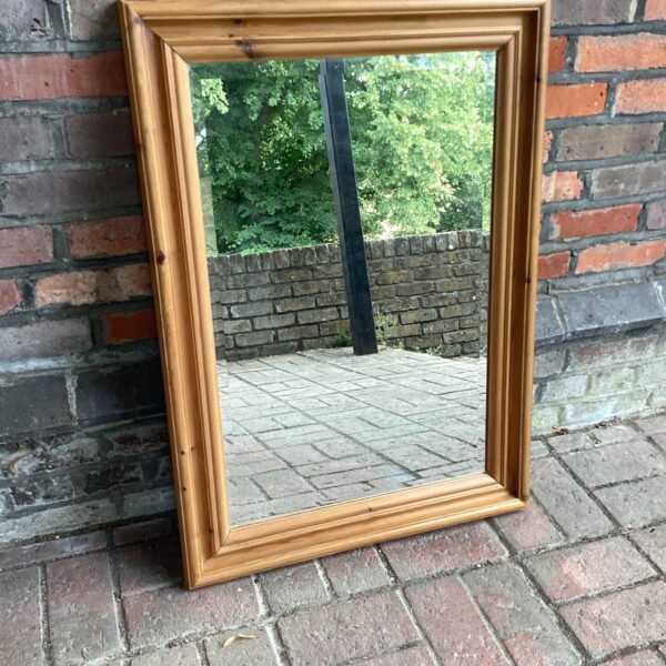 Rustic pine wall mirror for farmhouse style decor.