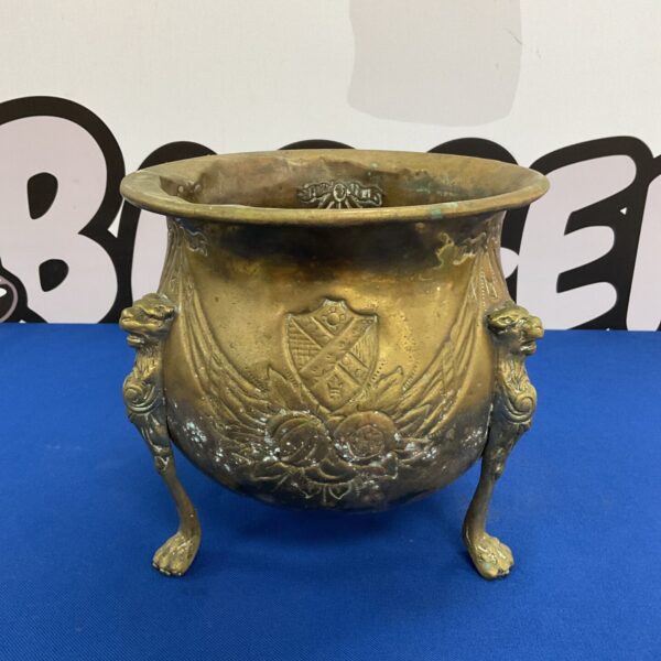 Vintage brass planter with elegant claw feet and a rich patina.