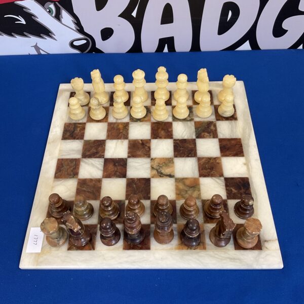 Marble chess set with checkered board and classic pieces.