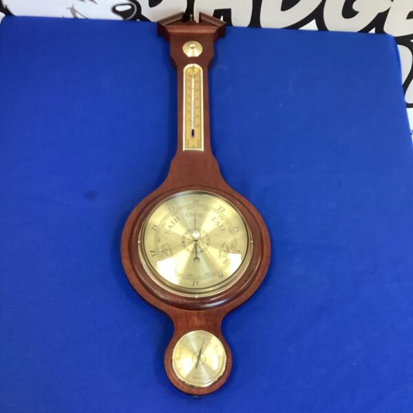 Vintage wall hanging barometer with Fahrenheit and Celsius scales.
