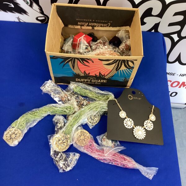 Large lot of assorted costume jewellery in a cardboard box.