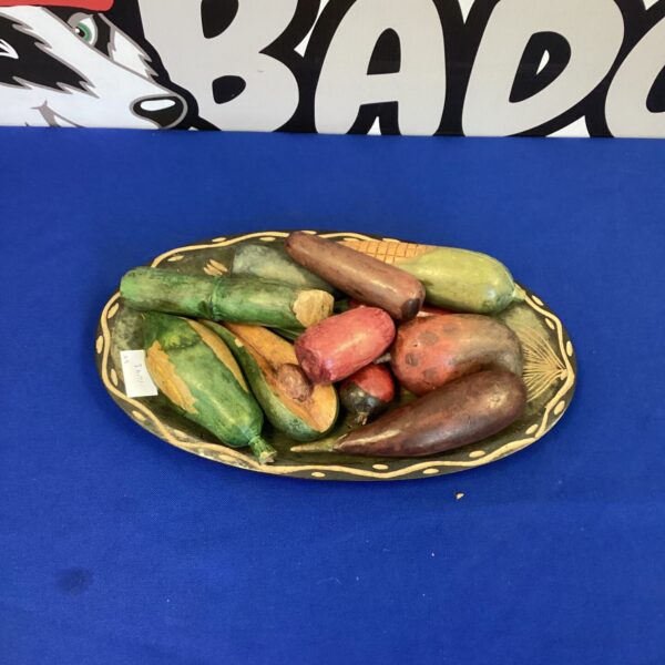 Rustic wooden fruit bowl with artificial fruit display.