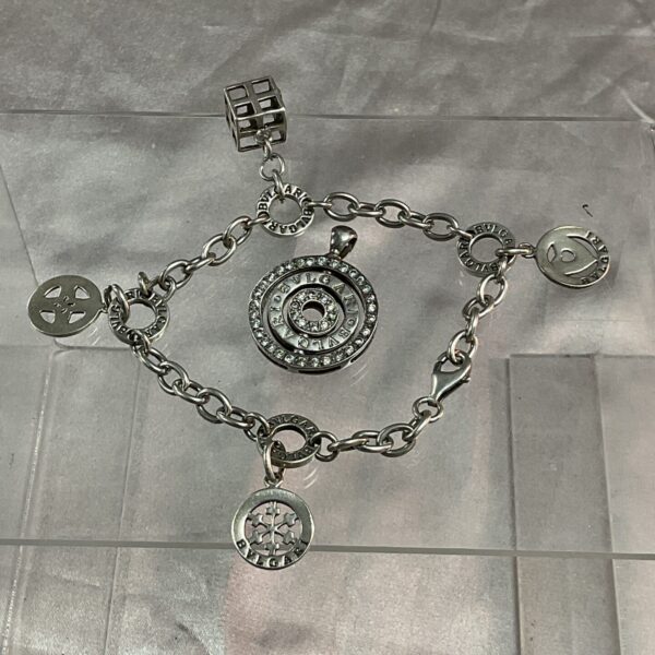 Silver Bulgari bracelet with pendant, showcasing Italian designer jewellery.