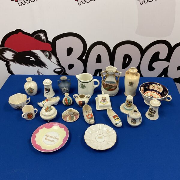 Collection of Victorian crestedware pottery with crests and emblems.