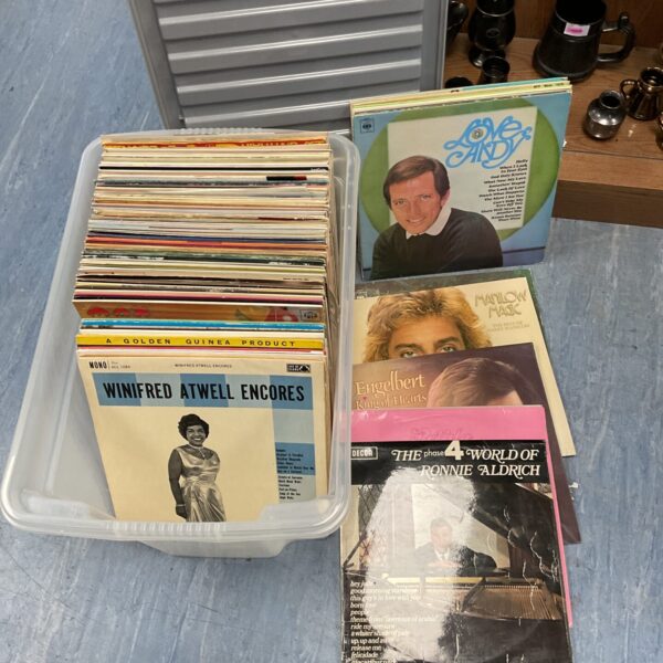 Large lot of vintage vinyl records in a plastic container.