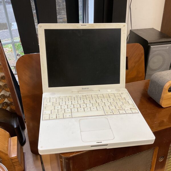 Vintage Apple iBook G4 laptop with clamshell design.