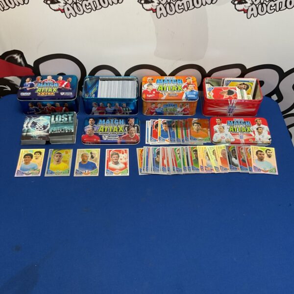 Collection of Match Attax cards in branded tins for football enthusiasts.