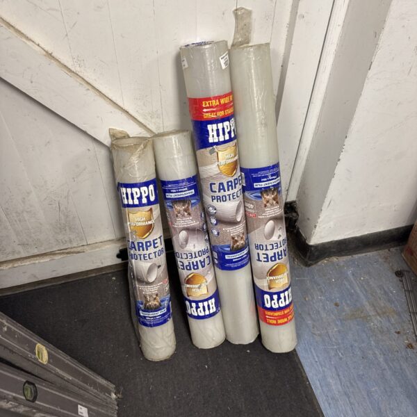 Four rolls of Hippo carpet protector film for floor protection.
