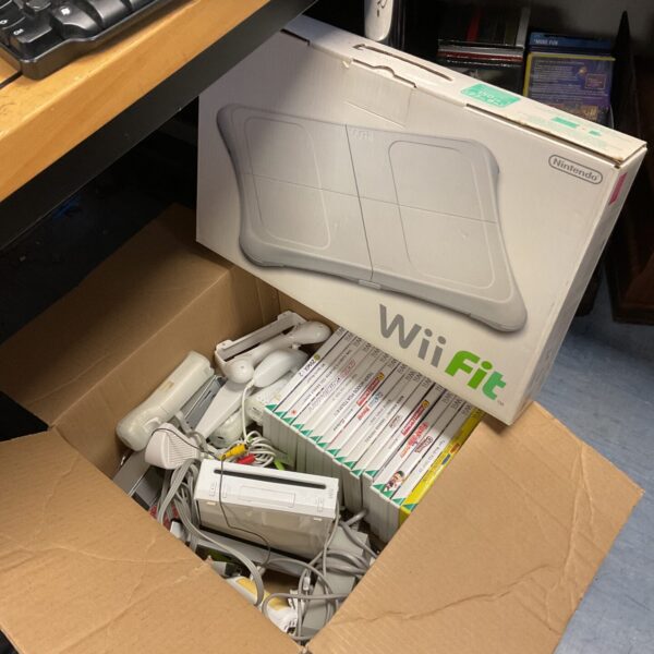 Nintendo Wii console bundle with games and controllers displayed in a box.