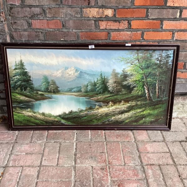 Large oil painting of a serene lake scene with mountains.