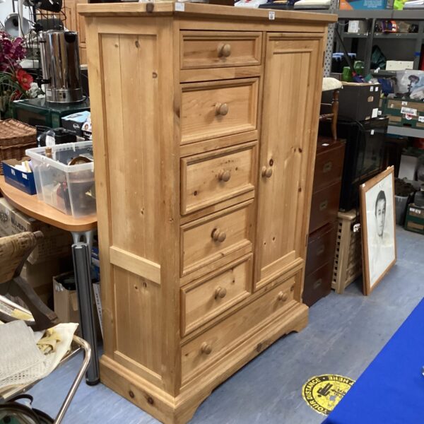 Vintage pine bedroom cabinet with drawers and door.