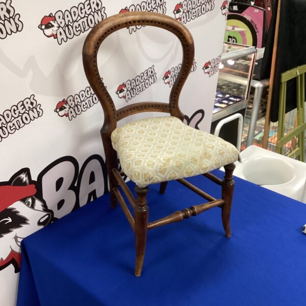 Antique child's balloon back chair with patterned seat.