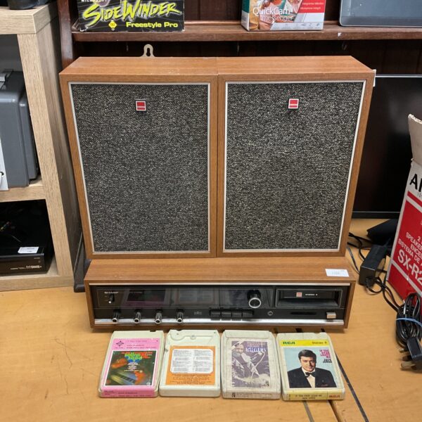 Vintage Sharp 8 track stereo system with speakers, retro audio player.