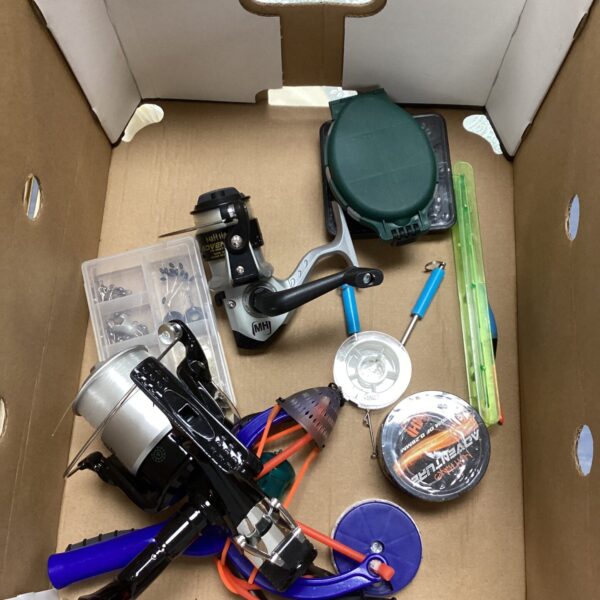 Vintage fishing reel selection with tackle box and accessories.