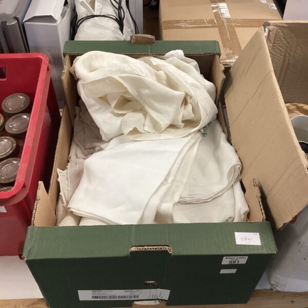 Assorted vintage linen pieces in a cardboard box.