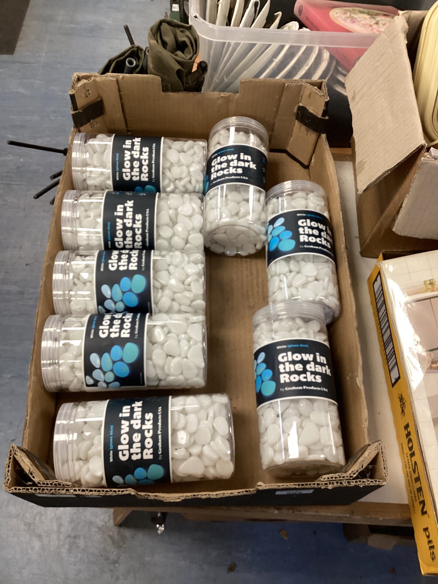 594 Eight tubs of glow in the dark rocks