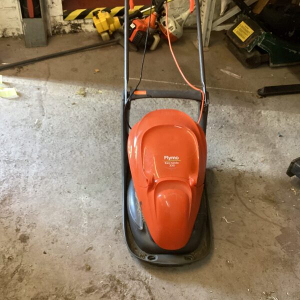 Orange Flymo Easi Glide electric lawn mower for garden maintenance.