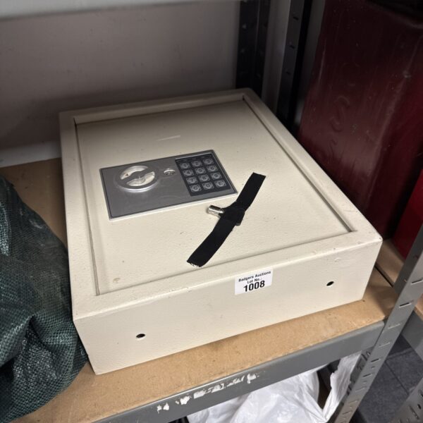 Front view of a digital wall safe with keypad and key slot.