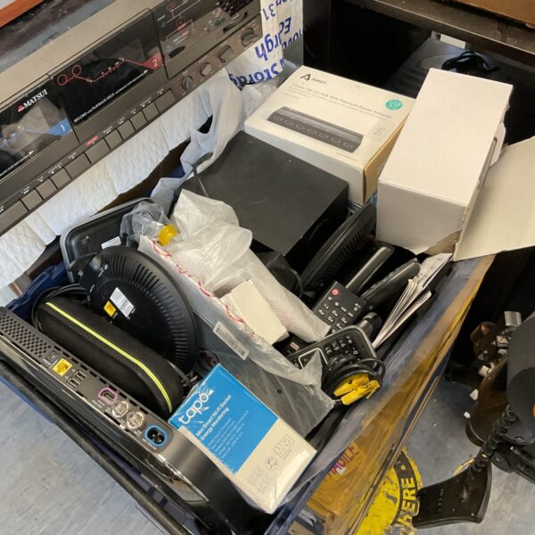 Mixed electrical lot with vintage remotes and a cassette player.