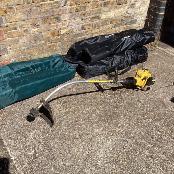 McCulloch petrol garden strimmer, showing the engine and shaft.
