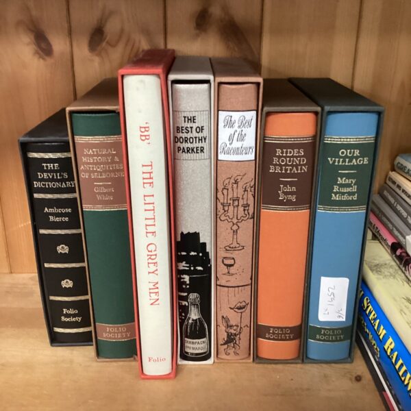 Vintage Folio Society book collection displayed on a shelf.