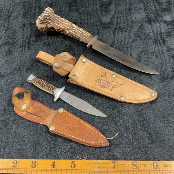 Vintage German horn handled knives with leather sheaths.