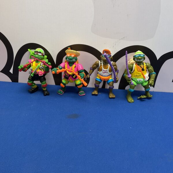 Vintage Ninja Turtles beach toys from the 1990s, collectible figures.