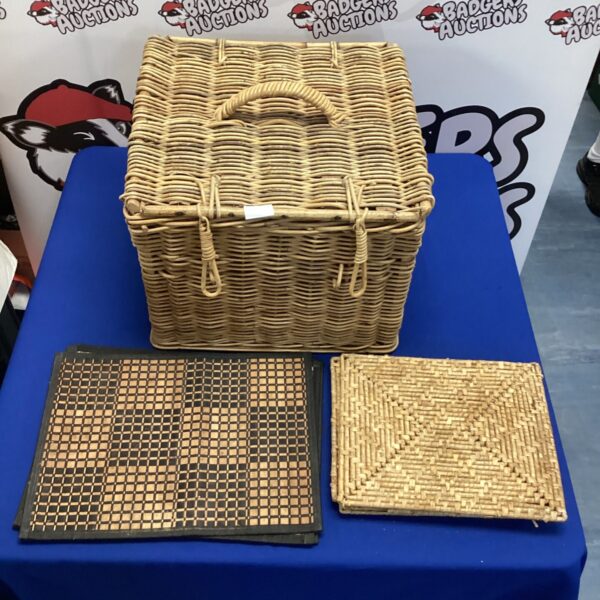 Vintage wicker picnic basket with woven placemats and table mats.