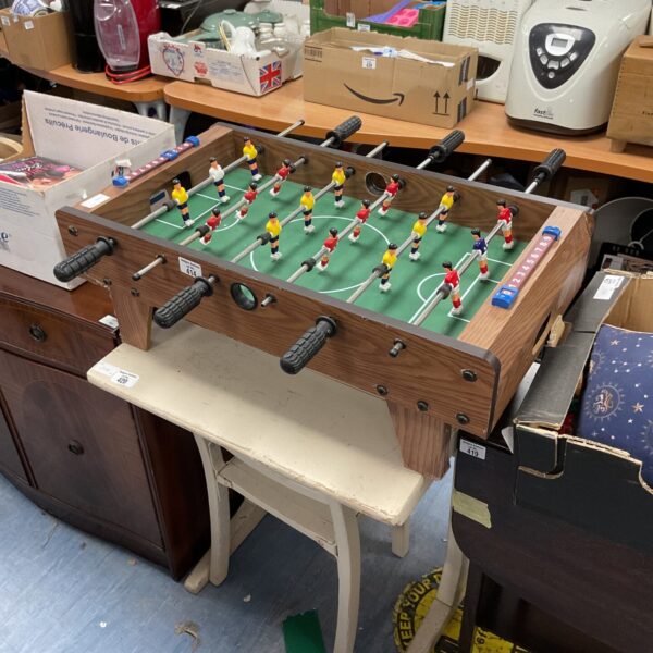 Vintage miniature table top football game with plastic players.