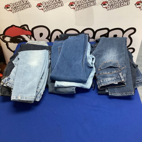 Assorted sizes of mixed jeans in a denim lot.