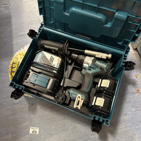 Makita cordless drill in open case with batteries and charger.