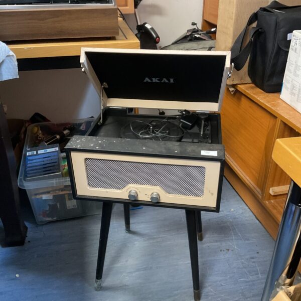Vintage Akai record player with wooden cabinet and tapered legs.