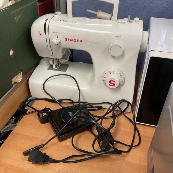Vintage Singer Tradition electric sewing machine in used condition.