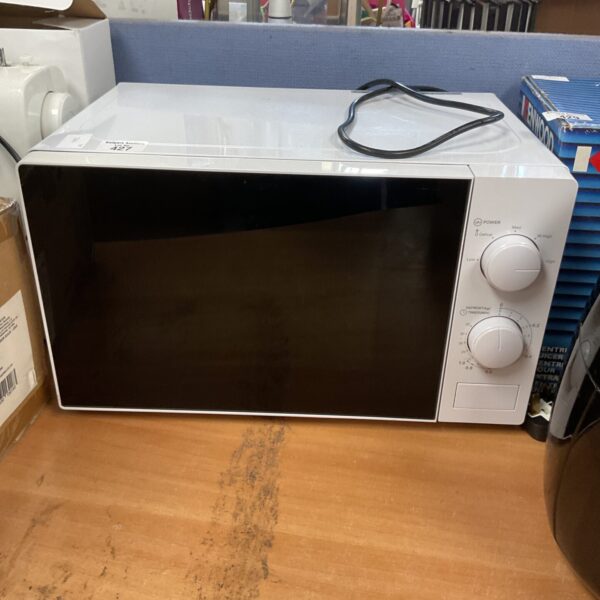 White Tesco microwave on a countertop, used kitchen appliance.
