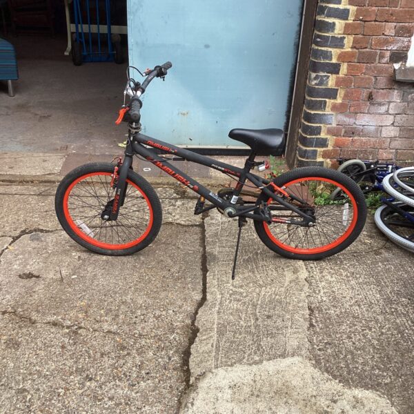Black and red freestyle bike, ideal for BMX or trick riding.