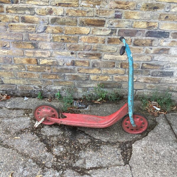 Red and blue vintage metal scooter, collectible toy.