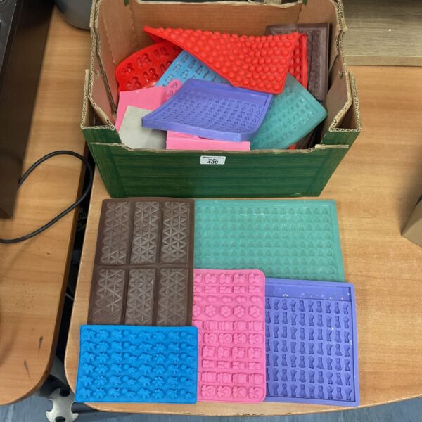 Assorted silicone chocolate moulds for baking and confectionery.