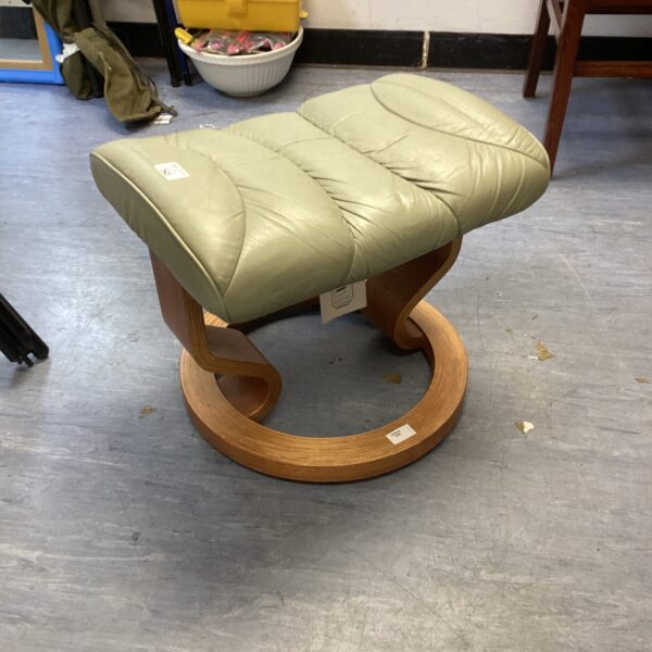 Leather Ekornes footstool for comfortable leg support.