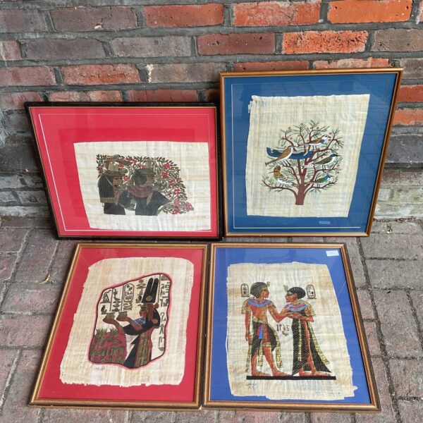 Framed Egyptian papyrus artwork depicting a figure with a bird.
