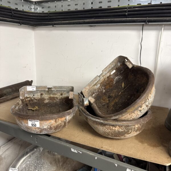Set of three vintage metal wall planters with weathered patina.