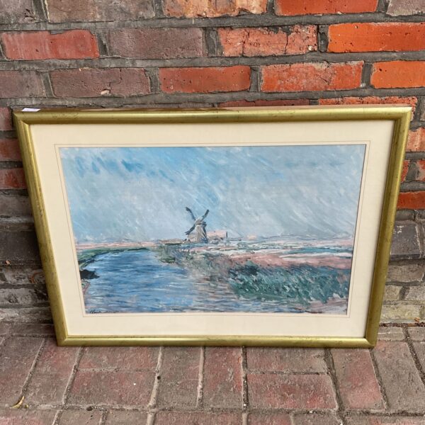 Framed Claude Monet style print of a windmill and tulip field.