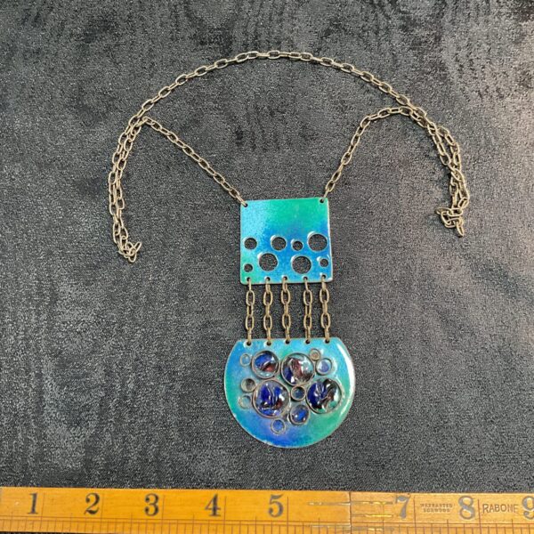 Vintage mid-century modern pendant necklace with blue enamel detailing.